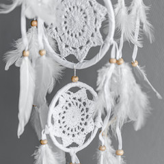 White crocheted dreamcatcher, an Indian amulet that protects the sleeper from evil spirits and...