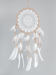 White dreamcatcher at gray background. Interior decoration. Native American Dreamcatcher