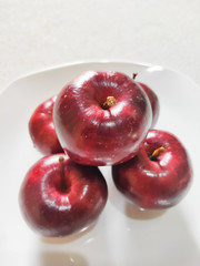 Apples on a white plate. Apples are rich in vitamin C, vitamin B6 and vitamin B1. One apple...