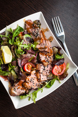 Salad with duck, sesame, cherry tomatoes and other