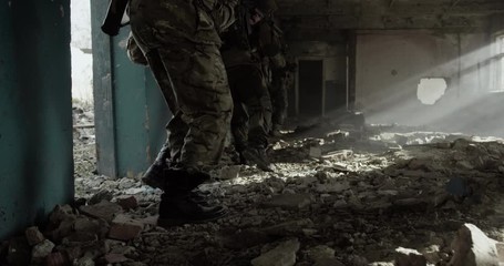 Group of soldiers walking together with equipment on a battlefield