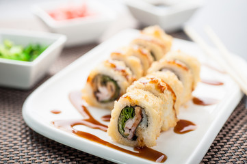 Hot sushi amay maki with sauce on a dish