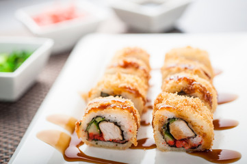 Hot sushi amay maki with sauce on a dish