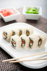 Uramaki sushi philadelphia sesame maki on a dish