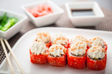 Uramaki sushi ikura maki on a dish