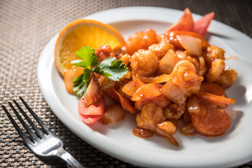 Chicken wok with carrots, onions and tomatoes