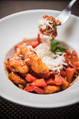 Fried spicy chicken with vegetables and cheese