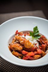 Fried spicy chicken with vegetables and cheese