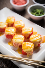 Hot sushi fritter maki on a white plate