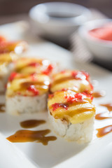 Hot sushi fritter maki on a white plate