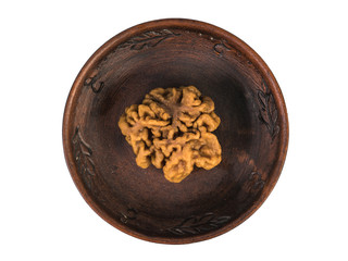 A large gyromitra mushroom in a clay bowl isolated on a white background.