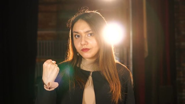 Angry young woman clenching her fist