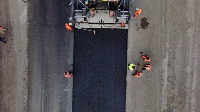 4K video. Top view of road works with asphalt paver.