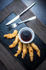 Chicken fillet pieces in tempura dough with sauce