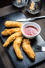 Chicken fillet pieces in tempura dough with sauce