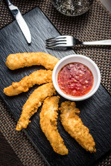 Chicken fillet pieces in tempura dough with sauce