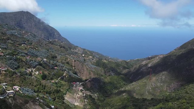 Light fluffy clouds drift over small mountain village of Galip&aacute;n, Venezuela, Caribbean Sea, aerial hyper lapse