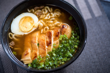 Spicy Ramen soup with chicken, spring onions, egg
