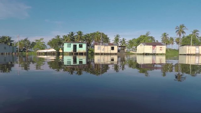 Daytime flight just above waters surrounding palafittes located in the town of Olog&aacute;, in the state of Zulia 