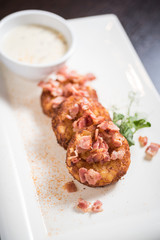 Potato rosti with bacon and sauce, deep fried