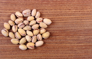 Pistachio nuts on wooden table, healthy eating