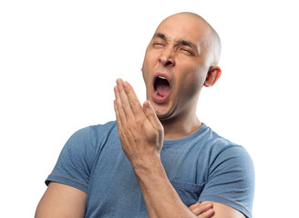 Photo of bald yawning man in blue tee shirt