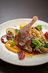Grilled duck leg with pearls, vegetables, onions