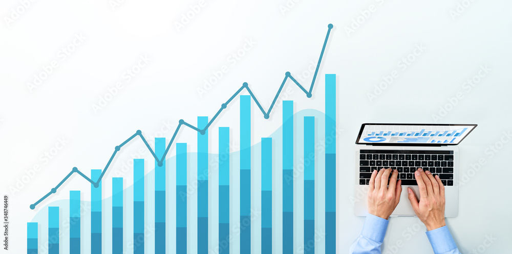 Poster blue graphs, charts and laptop computer. business man using laptop for analysis.