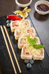 Sweet sushi rolls, strawberries, banana, chocolate