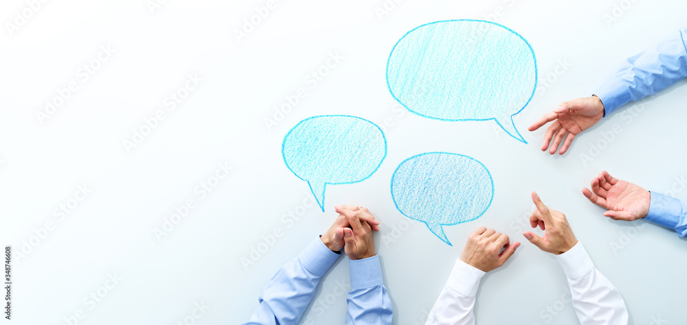 Aufkleber Top view of business meeting. Three men discussing at white table. Three speech balloon and copy space.