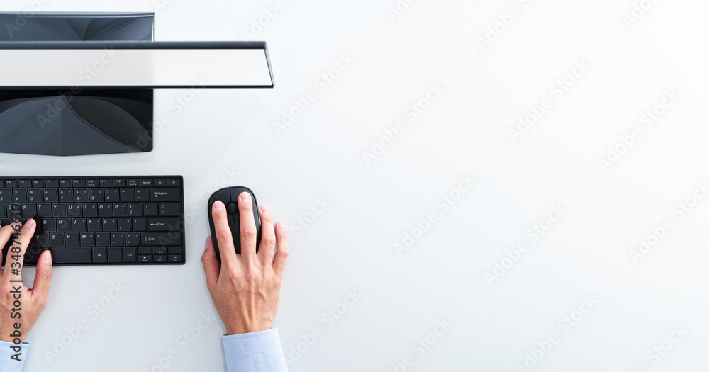 Aufkleber Top view of computer with blank display. Businessman clicking mouse on white background.