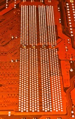 The back side of the electronic circuit of the computer motherboard.