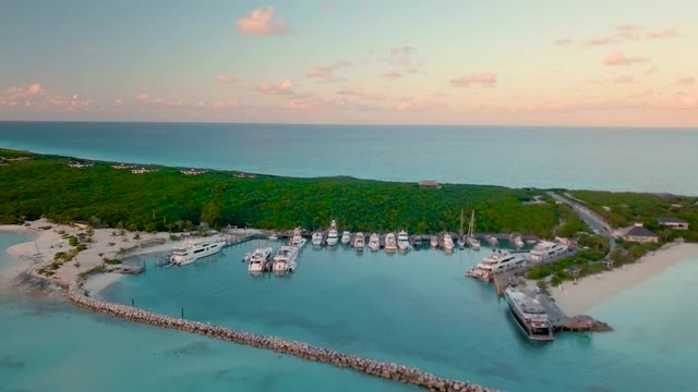 Private yachts anchored in harbor at sunset in the Bahamas