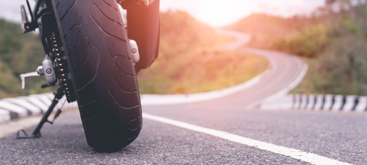 motorcycle in a sunny motorbike on the road riding.with sunset light. copyspace for your individual text. On the beautiful road. © PIPAT
