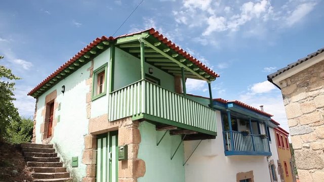 Pan shot of Tradicional Ucanha house facade in Portugal