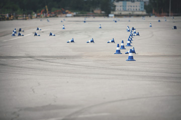 Traffic cones in empty parking space, asphalt with withe lines