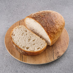 Loaf of freshly baked bread on a cutting board.