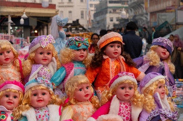 Fototapeta na wymiar Beautiful cute girl baby dolls for sale at retail shop at Christmas market, New Market area, Kolkata, West Bengal, India.