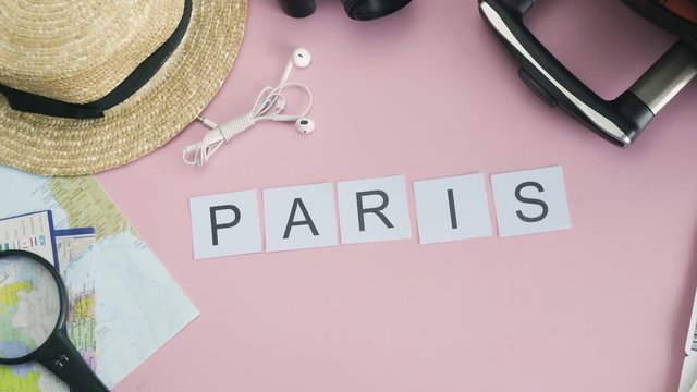 Top view hands laying on pink desk word PARIS