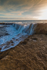 Fototapeta premium Waves Washing Over Exposed Coral Reef on Salt Pond Beach, Salt Pond Park,Hanapepe, Kauai, Hawaii, USA