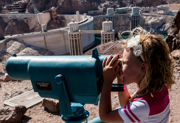 Young Girl Looking at The Hoover Dam Through Telescope.Hoover Dam, Nevada, USA