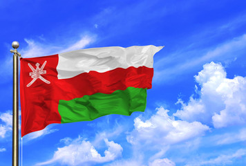 Fototapeta na wymiar Oman National Flag Waving In The Wind On A Beautiful Summer Blue Sky