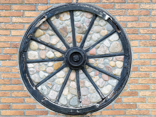 Close-up Of Metallic Wheel On Brick Wall