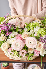 Woman florist creating beautiful bouquet in flower shop. Work in flower shop. Flowers delivery.