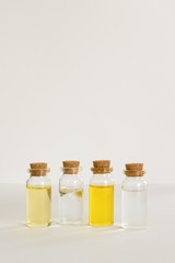 Transparent bottles of almond oil, jojoba oil and rose water for the production of natural environmentally friendly home cosmetics