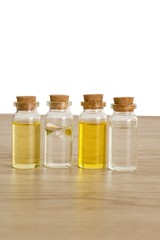 Transparent bottles of almond oil, jojoba oil and rose water for the production of natural environmentally friendly home cosmetics