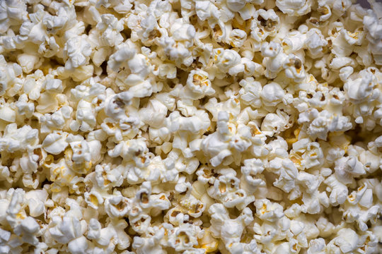 A scattering of cooked popcorn. View from the top. Background.