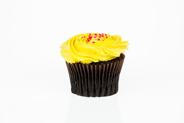 Yellow cupcakes with red powder on a white background isolated