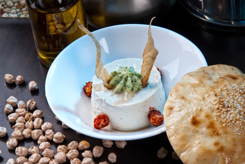 Healthy Homemade Creamy Hummus with Olive Oil and Pita Chips.