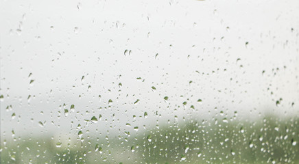 Rainwater splashing makes the window glass wet.